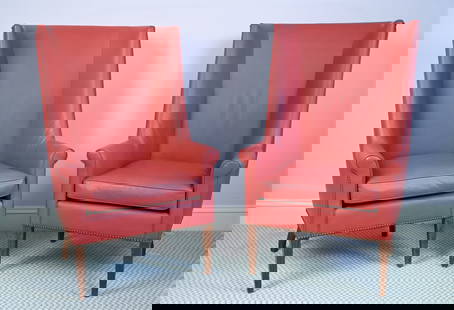 PAIR OF MODERN HIGH-BACK WING CHAIRS: Pair of contemporary wingback chairs with dramatic high backs, rolled arms, and tacked trim. No labels. Upholstered in brick-red leatherette. Dimensions: H 47.25" x W 29.25" x D 26.5" x SH 20" Conditi