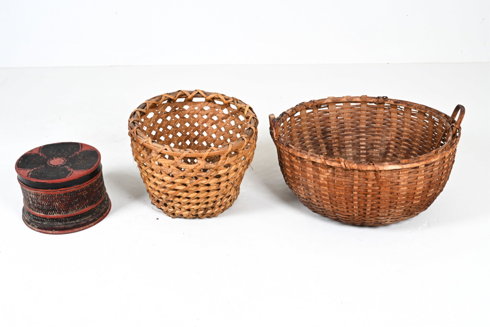 GROUPING OF VINTAGE HAND-WOVEN BASKETS: Dimensions: (Largest) H 14.75" x Dia 29" Condition: Wear consistent with age and use. Apparent sun fading. Some minor breaks in basket weaving. Minor scuffs and scratches to paint finish on smaller ba