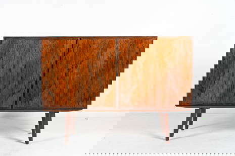 OMANN JUN ROSEWOOD SIDEBOARD CABINET, C. 1960'S: Danish Mid-Century sideboard or bar cabinet in richly figured rosewood, featuring minimalist lines and classic tapered legs. Produced by Omann Jun Mobelfabrik, c. 1960's. Dimensions: H 34" x W 47" x D