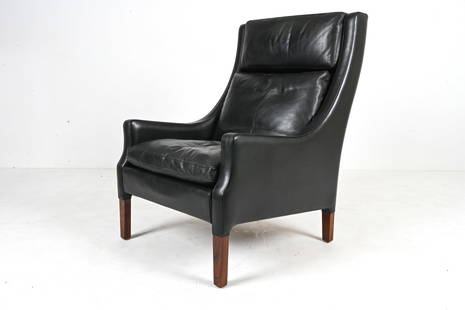 BORGE MOGENSEN-STYLE LEATHER HIGH-BACK EASY CHAIR: Scandinavian Modern lounge chair in black leather and rosewood, c. Late 20th Century. Dimensions: H 39" x W 27" x D 31" x SH 16" Condition: In excellent vintage condition overall; a few light scuffs a