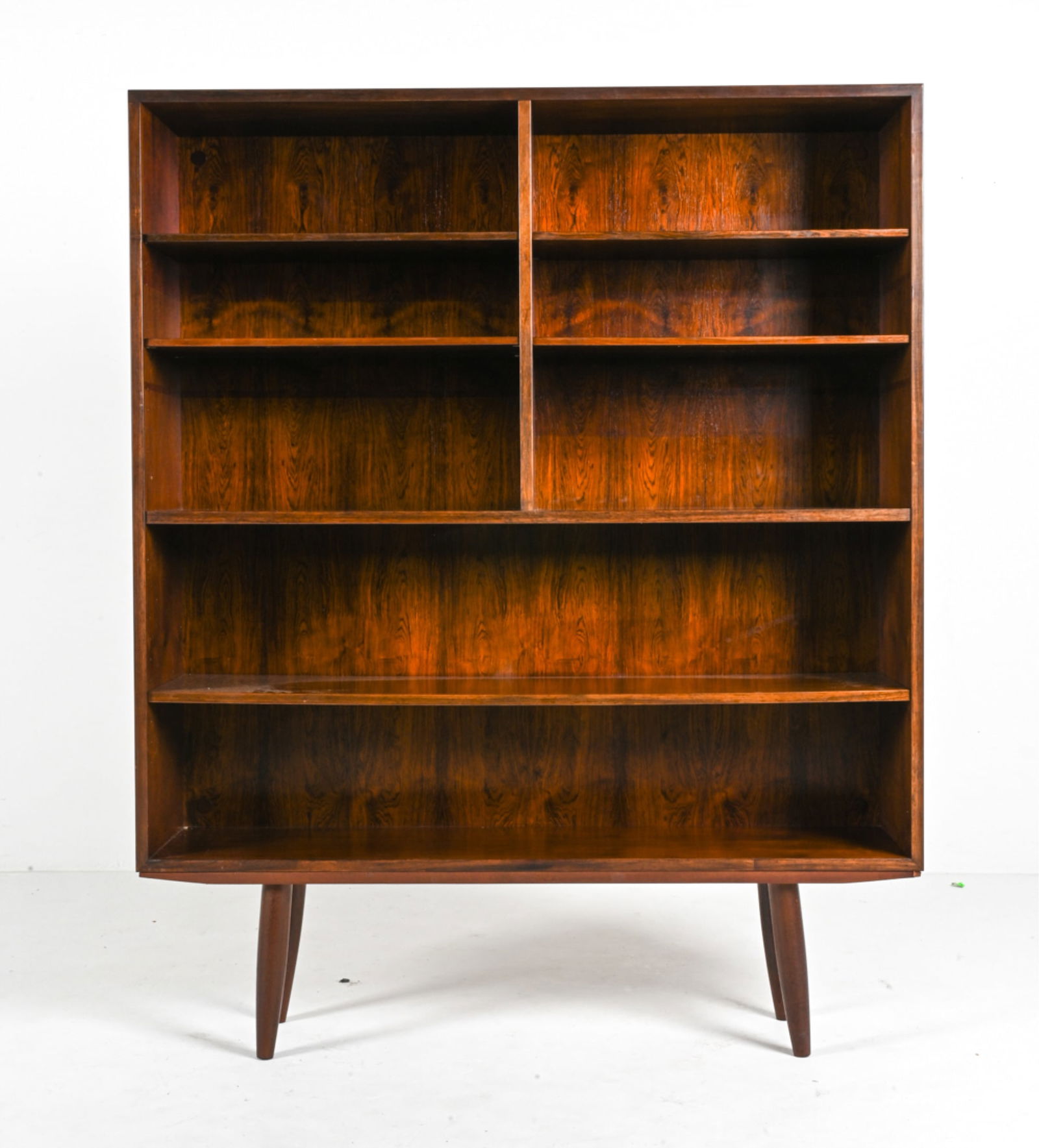 GUNNI OMANN FOR OMANN JUN ROSEWOOD BOOKCASE: Iconic Danish Mid-Century bookshelf in luxurious rosewood. Model No. 5, designed by Gunni Omann for Omann Jun, c. 1960's. Dimensions: H 58.5" x W 47.75" x D 11.75" Conditions: In very good vintage con