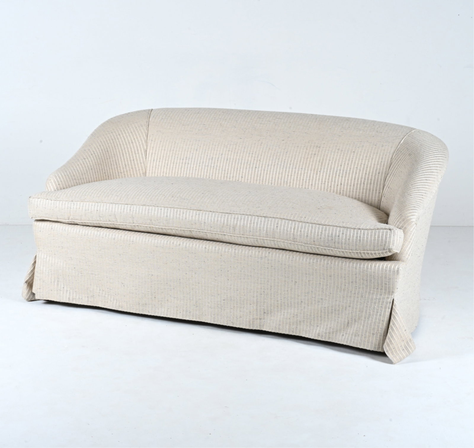 MODERN SKIRTED SETTEE IN CUSTOM WOVEN SILK FABRIC: Apparently unlabeled. Dimensions: H 31" x W 65" x D 34" x SH 18.5" Condition: In very good used condition overall; showing only light signs of wear.