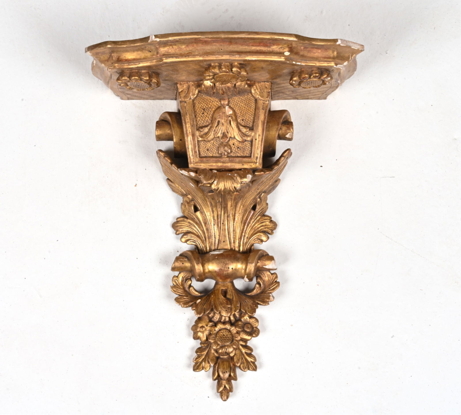 NEOCLASSICAL CARVED GILTWOOD & GESSO WALL BRACKET: 20th Century. Dimensions: H 15" x W 11.25" x D 8.5"Condition: Chips and losses to gilding and gesso scattered throughout. Patina and wear consistent with age.