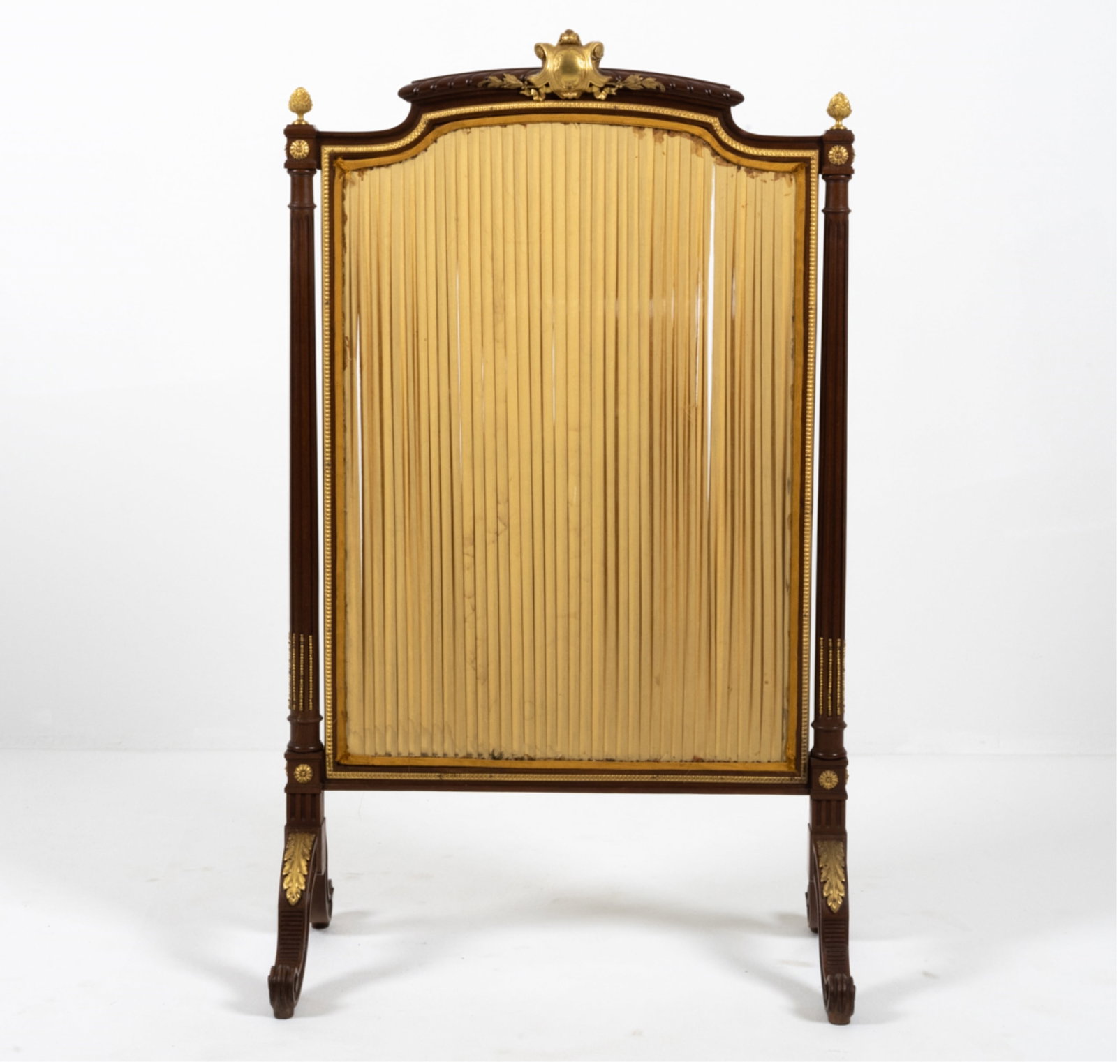 FRENCH ORMOLU-MOUNTED FIRE SCREEN: 20th Century. Dimensions: H 44.5" x W 26" x D 15.5" Condition: Fabric with soiling and tears. One small stress crack to wood at finial; a few faint gouges and scuffs.
