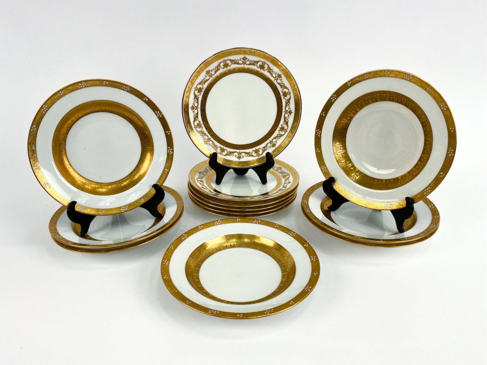 (13) MINTON GOLD IMPRESSED PORCELAIN PLATES: Marked with New York retailer on back. Dimensions: Dia. 9" Condition: Very light rubbing to the rims.