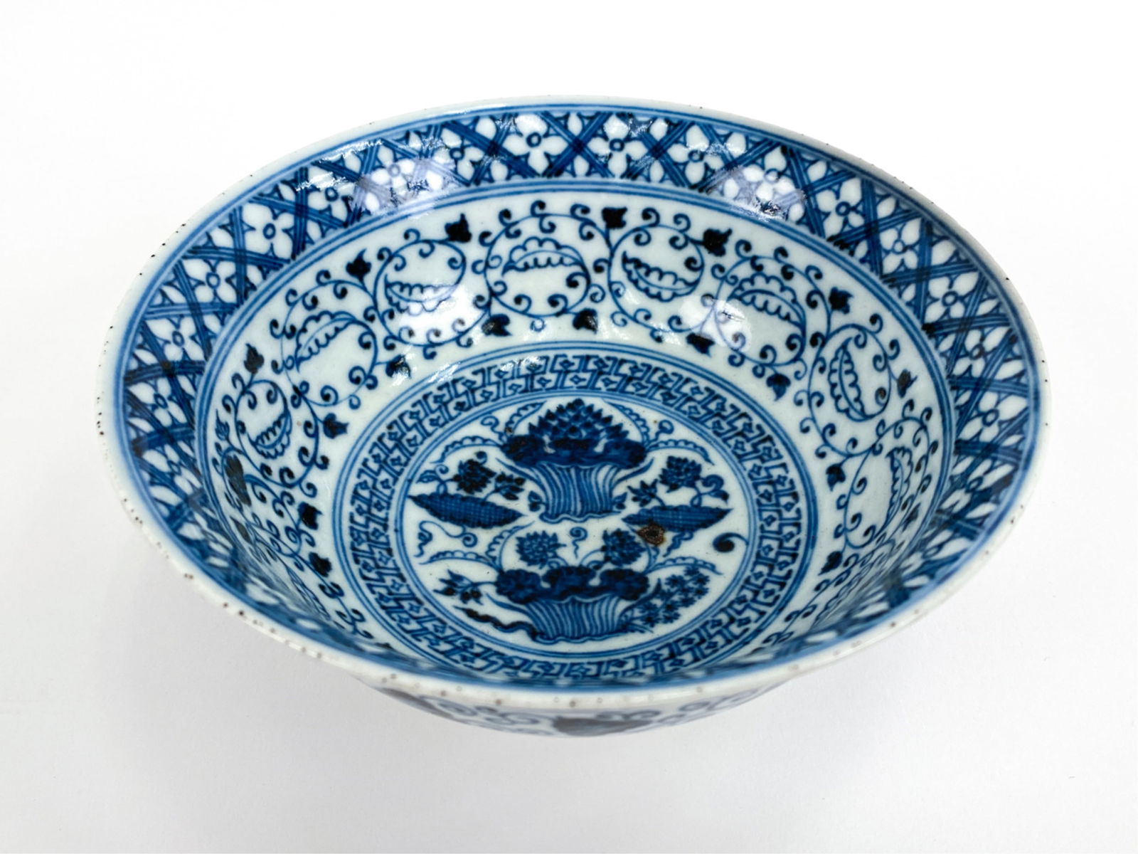 CHINESE MING-STYLE BLUE & WHITE BOWL: Deep bowl with detailed design. Decorative mark underneath. Dimensions: H 3" x Dia. 6" Condition: Some roughness to rim.