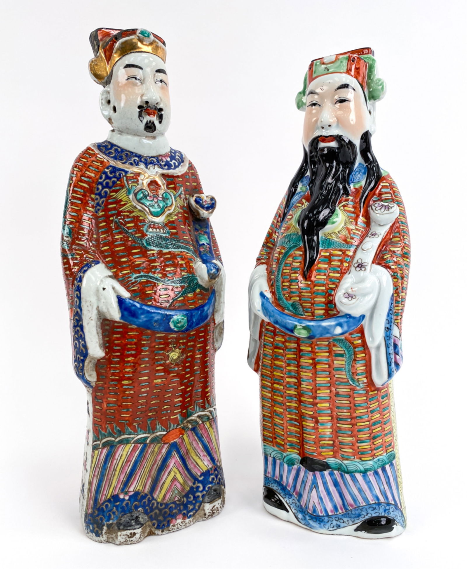(2) CHINESE PORCELAIN FIGURES: Not a pair; of different color clay. Both unmarked. Dimensions: (Taller) H 19" x W 6" x D 4.5" Condition: Taller with glaze flaws throughout.