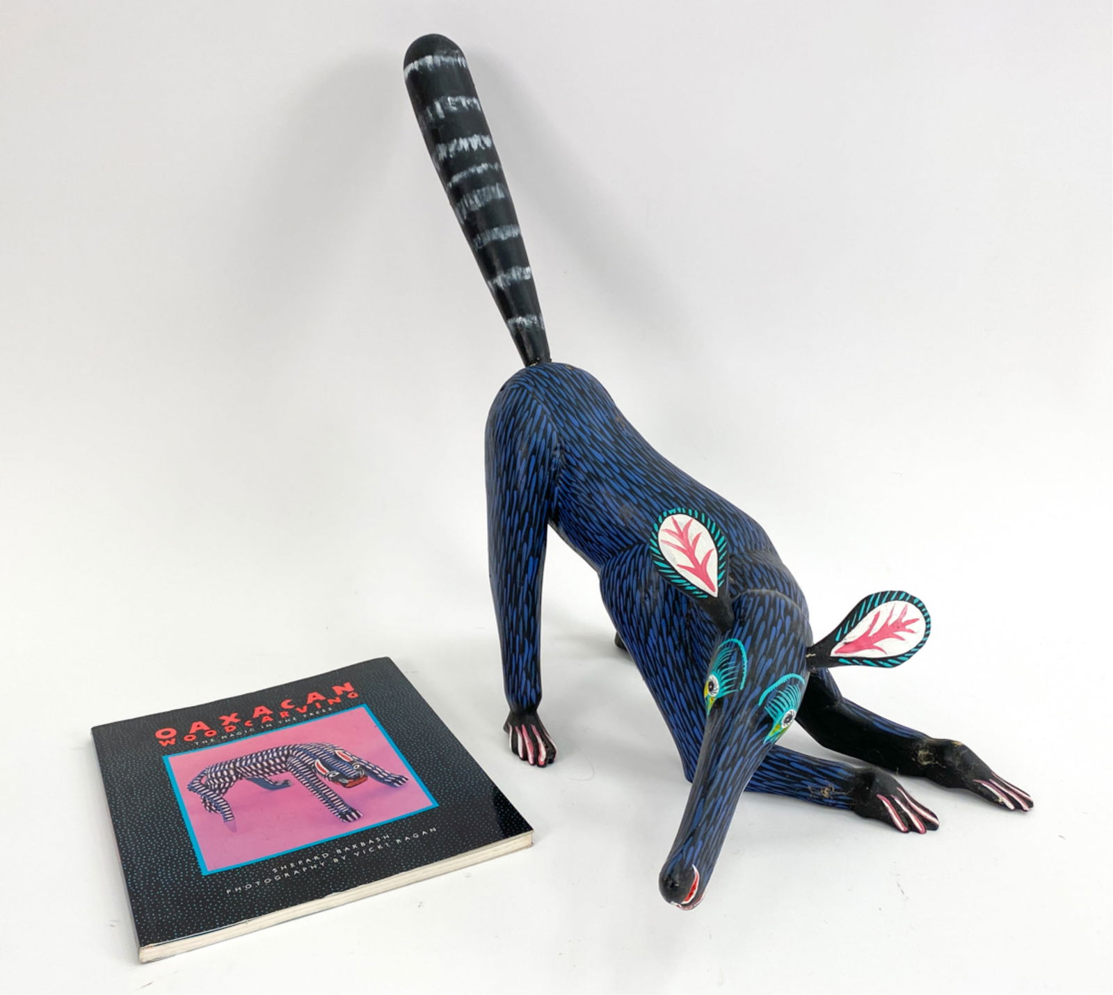 OAXACAN ANTEATER SCULPTURE: Painted, carved wood. Signed Alejandrino F. underneath. Dimensions: H 9" x W 16" x D 7" Condition: Ears and tail detached and retained. A couple spots of rubbing and paint loss.