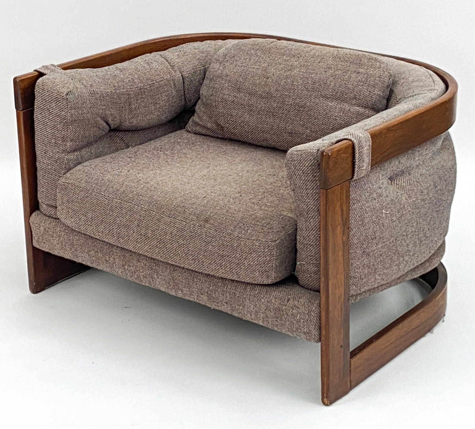 MID-CENTURY ROSEWOOD LOUNGE CHAIR: Rosewood lounge chair. Apparently unmarked. Dimensions: H 25" x W 40" x D 32" Condition: Minor surface wear consistent with age and use. Some scuffs, marks and scratches to wood frame. Soiling, stains