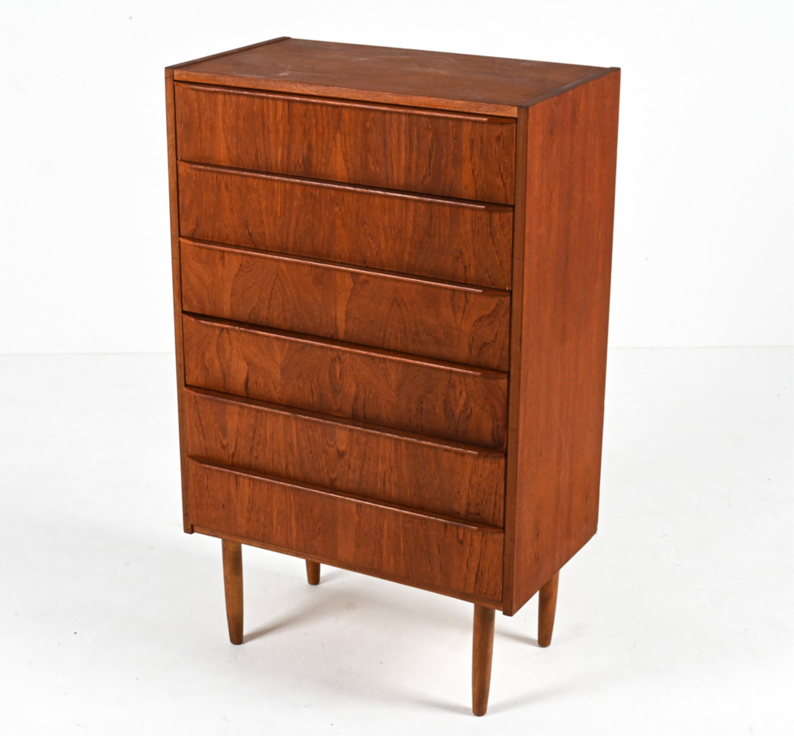 DANISH TEAK CHEST OF DRAWERS, C. 1970'S: Dimensions: H 40" x W 24.75" x D 14" Condition: Chest presents very well overall; a few faint areas of soiling/water spots; a few scattered dings and scuffs. Light wear consistent with age and use. G2