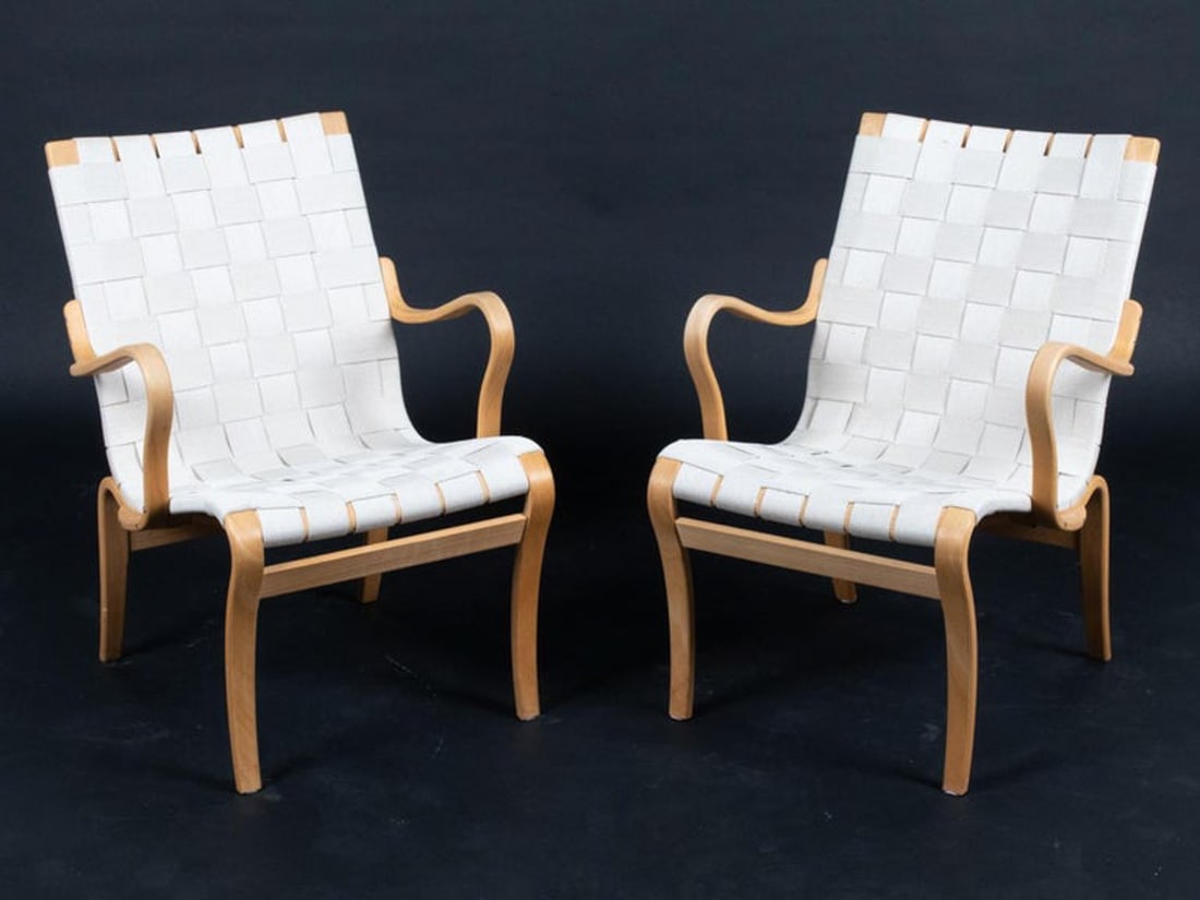 PAIR OF BRUNO MATHSSON "MINA" ARMCHAIRS: A staple of Bruno Mathsson's iconic Scandinavian midcentury design canon, the seeds of the "Mina" armchair were sewn in the late 1930s during Mathsson's flourish of inspiration to create a trio of cha