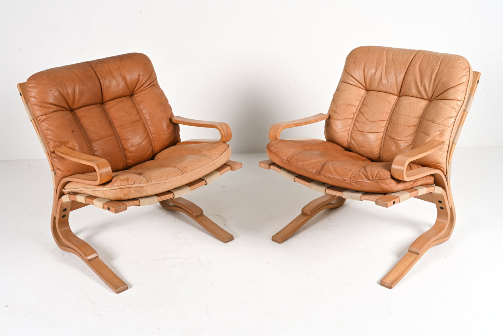 (2) EINAR HOVE SKYLINE BUFFALO LEATHER ARMCHAIRS: Bent beech wood, patinated buffalo leather, and canvas. Model "Skyline", designed by Einar Hove for Hove Mobler, Denmark, c. 1970's. Dimensions: H 33" x W 26" x D 30" x SH 21" Condition: Natural patin