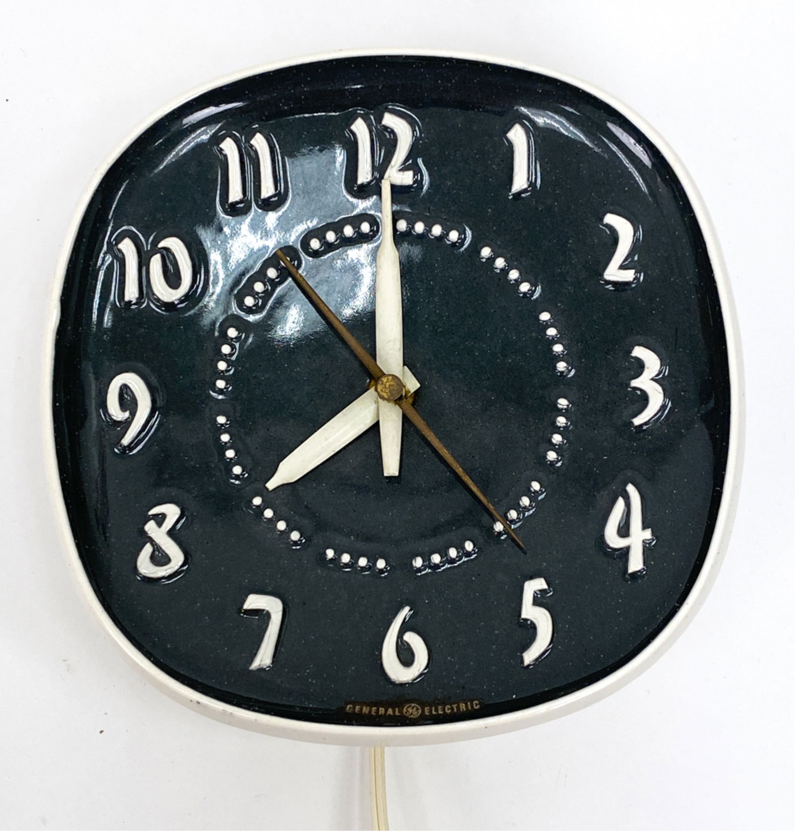 RUSSEL WRIGHT CERAMIC WALL CLOCK: Mid-Century Russel Wright ceramic electric wall clock for General Electric. Impressed Russel Wright mark verso. Dimensions: Dia. 8" x D 2.75" Condition: Minor surface wear, marks and tarnish consisten