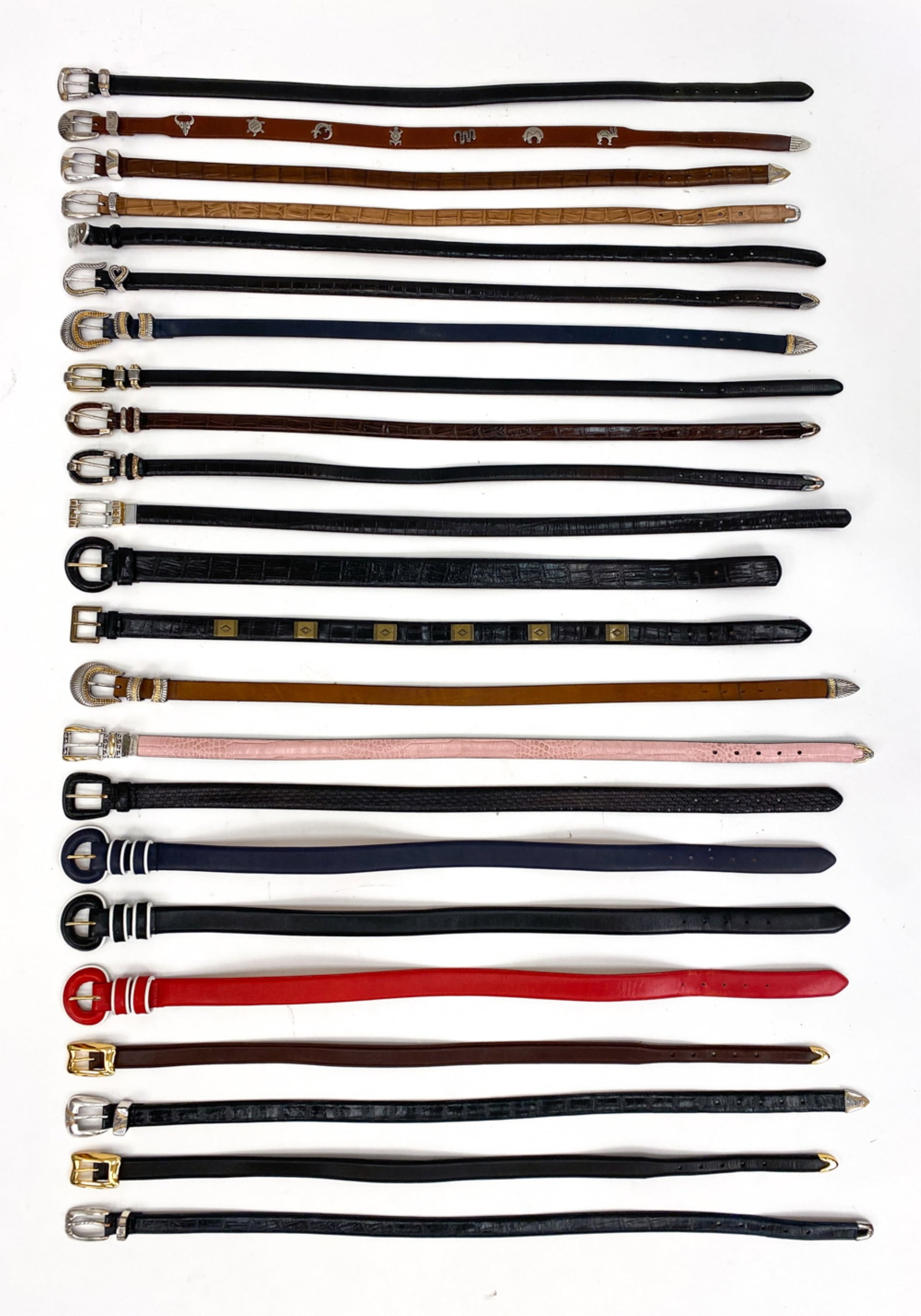 GROUPING OF LEATHER BELTS: c. 1990's. Various makers, styles. Including sizes S-L. Condition: Minor wear consistent with use.