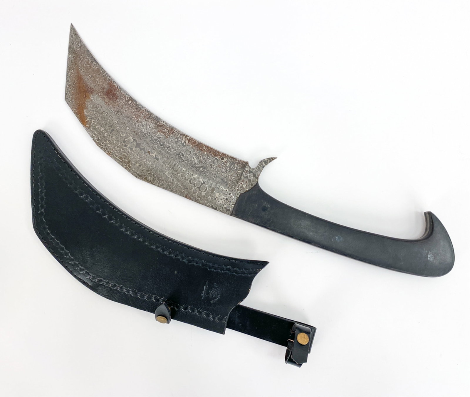 REPLICA DAMASCENE STEEL WEAPON: Custom sheath marked "The Lord of Metal." Device mark on the blade. Dimensions: (With sheath) L 25" x W 7" x D .75" Condition: Some rust on the blade. Handling wear to the handle.