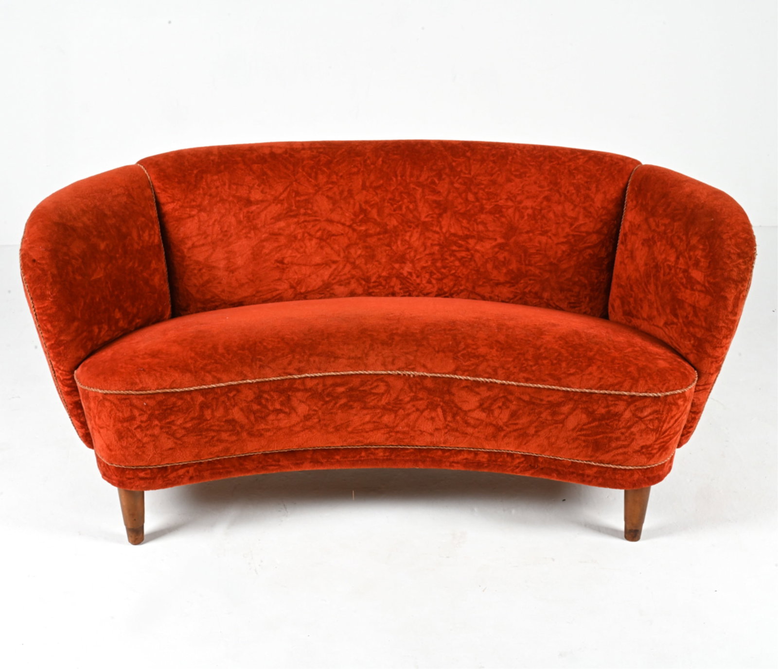 DANISH BANANA SOFA IN RUST CRUSHED VELVET, 1940'S: Fabulous curved cocktail sofa in the style of Viggo Boesen or Flemming Lassen, finished in rich rust-orange crushed chenille velvet with beech wood legs. Dimensions: H 27.75" x W 60" x D 28" x SH 19"