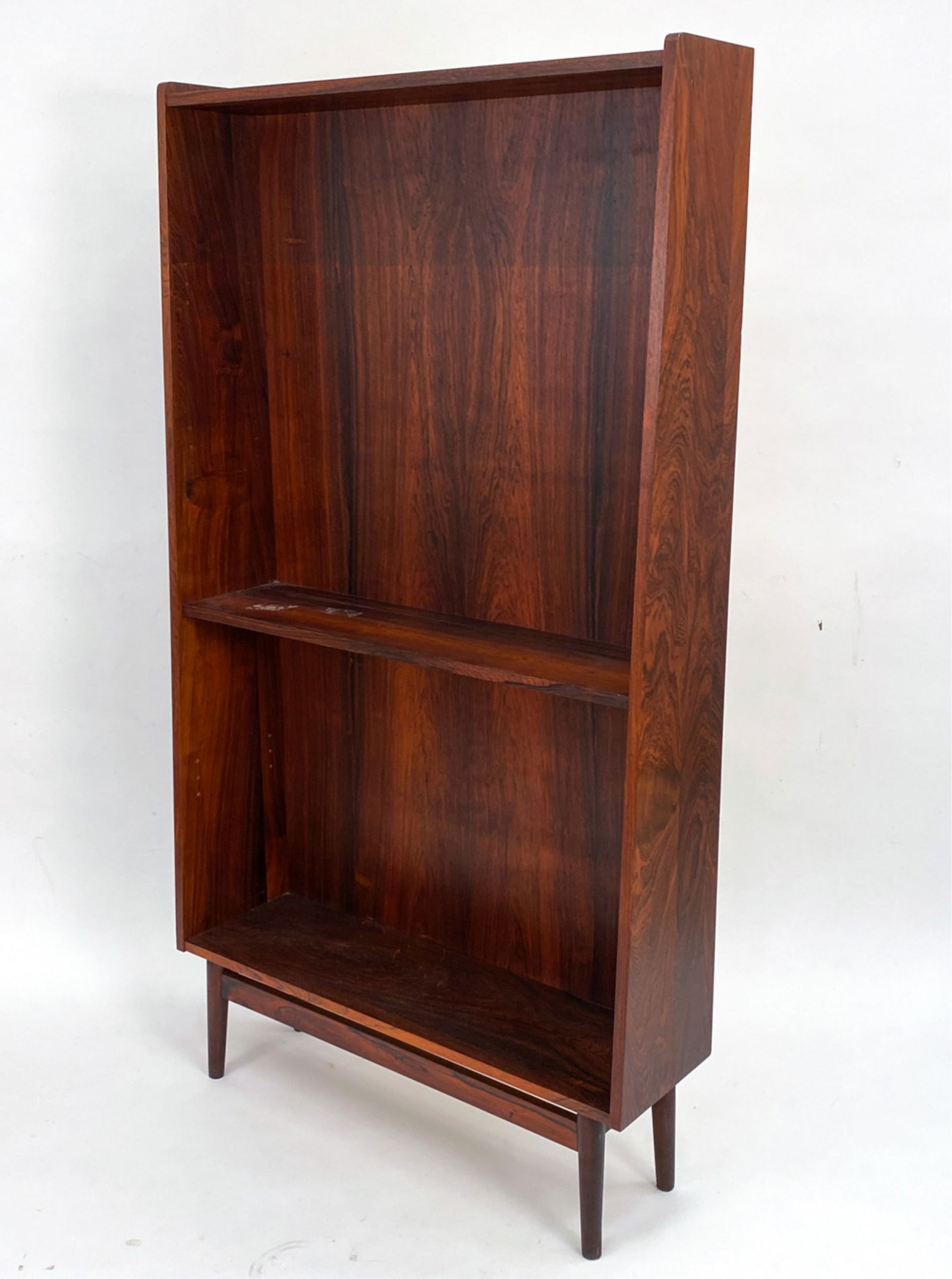 JOHANNES SORTH ROSEWOOD BOOKCASE: Mid-Century Johannes Sorth rosewood bookcase. Label verso. Dimensions: H 71.75" x W 39.5" x D 11" Condition: Minor surface wear, scratches and loss to veneer consistent with age and use. Missing shelv