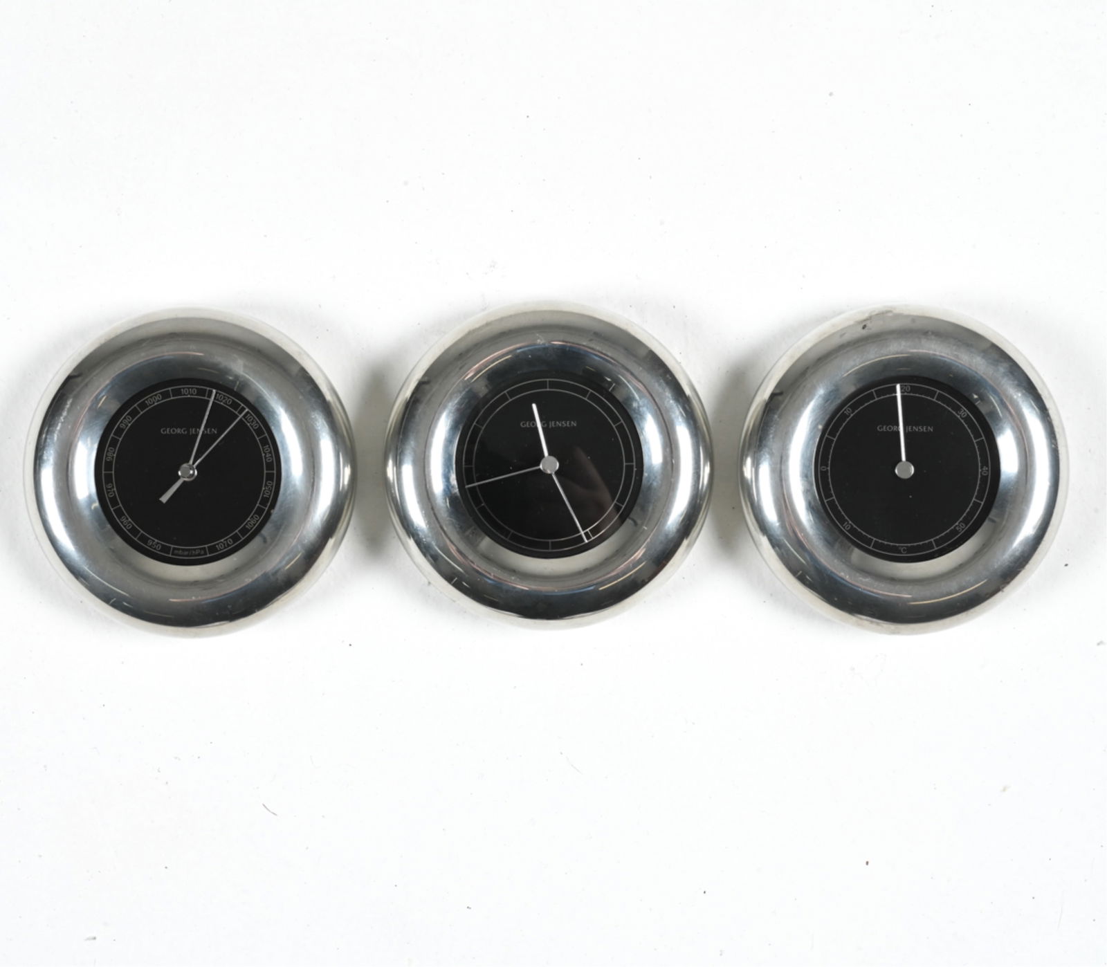 MIKKELSEN FOR GEORG JENSEN MODERN WEATHER STATION: Highly decorative Danish Modern three-piece wall hanging weather station, designed by Andreas Mikkelsen for Georg Jensen, c. 1980's-1990's. Set consists of a quartz clock, thermometer, and barometer/h