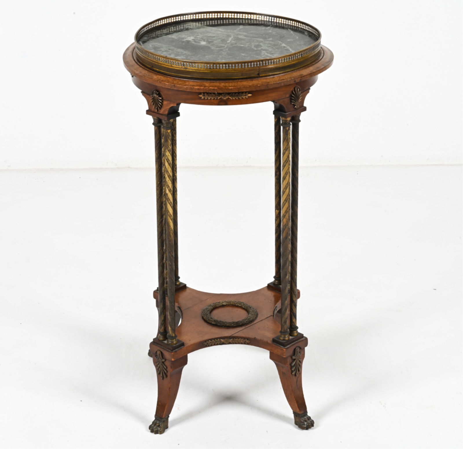 MARBLE-TOP GUERIDON TABLE IN THE LOUIS XVI STYLE: Early 20th Century. Dimensions: H 31.5" x Dia. 16.5" Condition: Table presents well overall. Repair to wood at the top of one leg. Sun fading, nicks, dings and finish rubs to wood. Natural patination