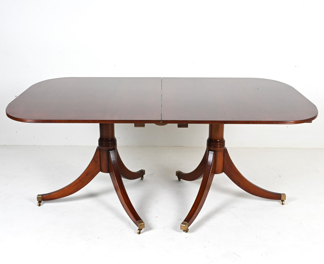 MAHOGANY DOUBLE PEDESTAL DINING TABLE: With (2) inset leaves. Stamped J M 37/6 underneath. 20th Century. Dimensions: (Without leaves) H 30.75" x W 72.25" x D 47.5" ; Each leaf measures 24.25" wide. Condition: Table presents beautifully ove