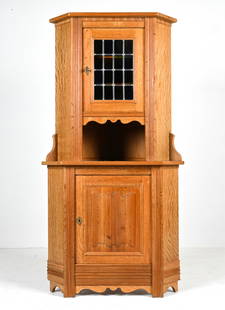 SCANDINAVIAN OAK & STAINED GLASS CORNER CABINET: Scandinavian Brutalist corner cabinet in the style of Henning Kjaernulf, featuring solid quarter-sawn white oak construction with a leaded stained glass panel decorating the upper door. Two-piece cons