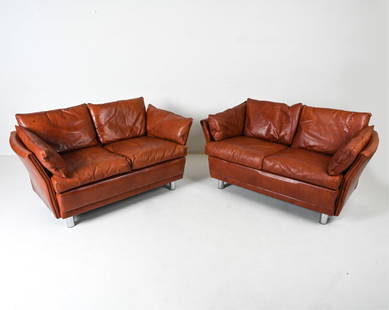 PAIR OF 1970'S SCANDINAVIAN LEATHER TWO-SEAT SOFAS: With polished chrome legs. In the style of Svend Skipper or Dux, c. 1960's-1970's. Dimensions: H 29" x W 69" x D 28" x SH 19" Condition: In very good vintage condition overall. Natural patination and