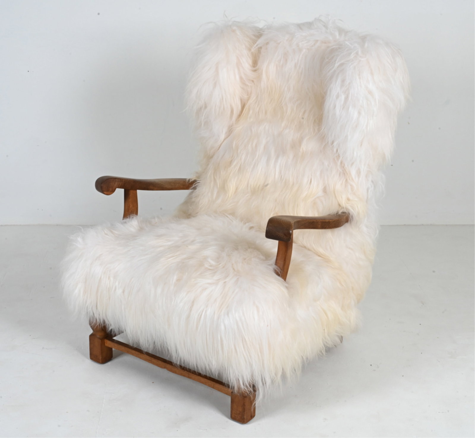 DANISH OAK & ICELANDIC SHEEPSKIN WINGBACK CHAIR: In the manner of Fritz Hansen, c. 1960's-1970's. Dimensions: H 41" x W 32" x D 29" S.H. 16" Condition: Presents very well. Light wear consistent with age and use.