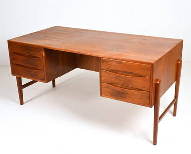 ATTR. ARNE VODDER DANISH TEAK EXECUTIVE DESK: Danish Modern desk in lustrous teak, with six drawers on one side and bookshelves on the reverse. Design attributed to Arne Vodder, c.1960's. Dimensions: H 30" x W 61" x D 30.5" Condition: Missing key