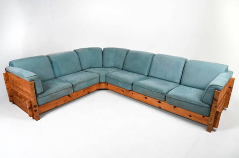 SCANDINAVIAN BRUTALIST PINE SECTIONAL SOFA: Dimensions: H 23" x W 146" x D 91" Condition: Showing signs of wear including water marks mid frame and repair to back leg corner. Light sun fading and soiling to upholstery.