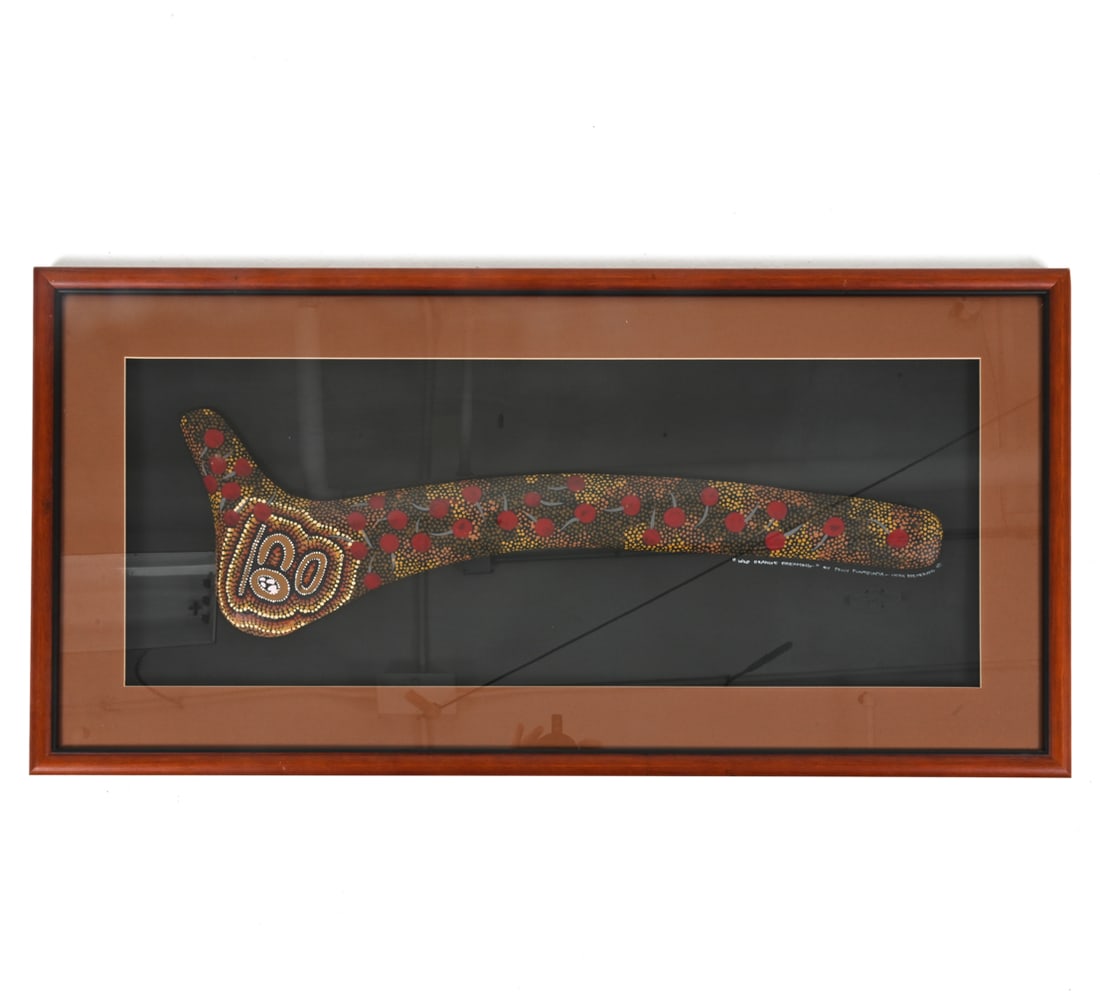 POLLY PUNTJUNTA ABORIGINAL WARRIOR BOOMERANG: Mounted in presentation frame. Titled "Wild Orange Dreaming", signed and inscribed "Hook Boomerang NT" on backing below boomerang. Provenance: Dragon Gallery. With original receipt. Dimensions: (Frame