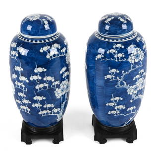 PAIR OF CHINESE BLUE & WHITE PORCELAIN LIDDED URNS: In the Kangxi style. Dimensions: (Without stand) H 11" x Dia. 5.5" Condition: Pair presents beautifully; no signs of chips, cracks, or repairs.