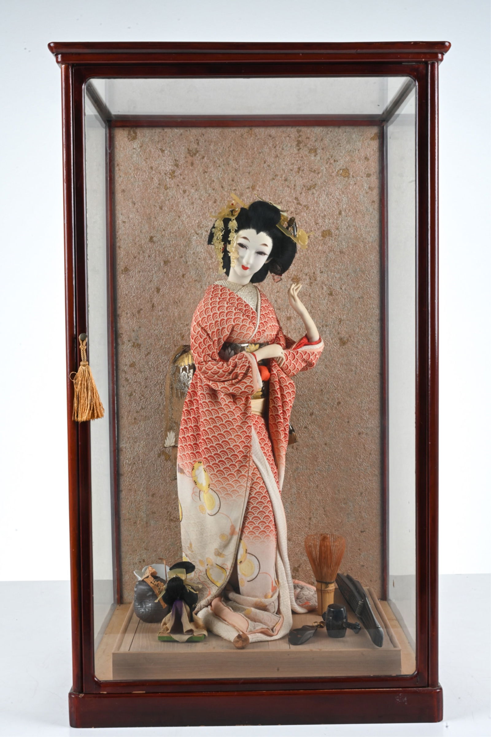 JAPANESE FABRIC GEISHA DOLL & ACCESSORIES: Fabric doll with beautiful silk kimono, surrounded by artfully assembled accessories in a lacquered wood and glass display case. 20th Century. Provenance: Collection of Mr. and Mrs. Eric Sloan, O. Run