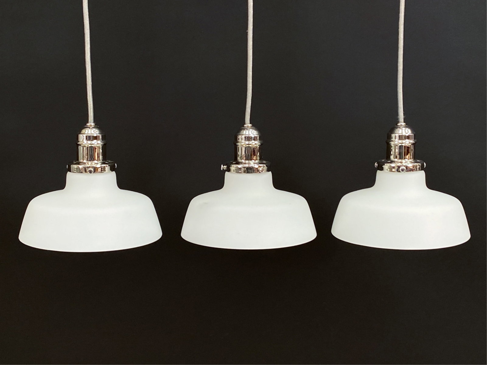 (3) HUDSON VALLEY LIGHTING PENDANT LAMPS: Trio of Hudson Valley Lighting frosted glass pendant lamps. Dimensions: (Shade only, not cord) H 6.5" x Dia. 7.25" Condition: Minor surface wear and scratches consistent with age and use. Untested.