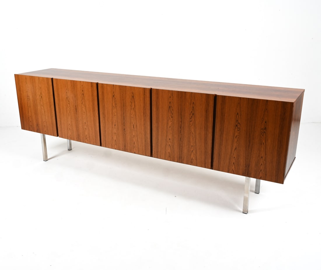 GERMAN ROSEWOOD SIDEBOARD, 1970'S: Minimalist silhouette, with chrome-finished legs. Dimensions: H 32.5" x W 95" x D 18.5" Condition: Sun fading, a few minor dings and scratches to top; minimal pitting to legs. PC088