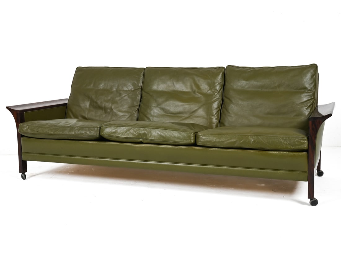 ATTR. ARNE VODDER ROSEWOOD & LEATHER SOFA: An exceptional three-seat sofa in solid rosewood and olive green leather, attributed to Arne Vodder, c. 1960's-1970's. On casters. Dimensions: H 30" x W 78.75" x D 27.5" x SH 14.5" Condition: In very