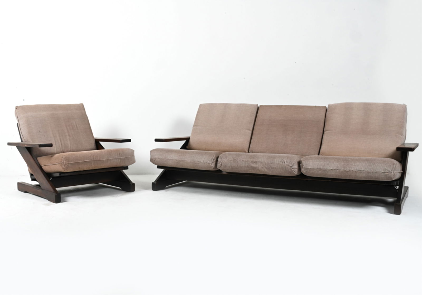 MANNER OF WEGNER DUTCH OAK SEATING SUITE, 1970'S: An unusual and substantial seating suite in dark stained oak and gray fabric, with a z-shaped side profile. In the style of Hans Wegner, c. 1970's. Dimensions: (Sofa) H 29" x W 81.5" x D 33" x SH 14.5