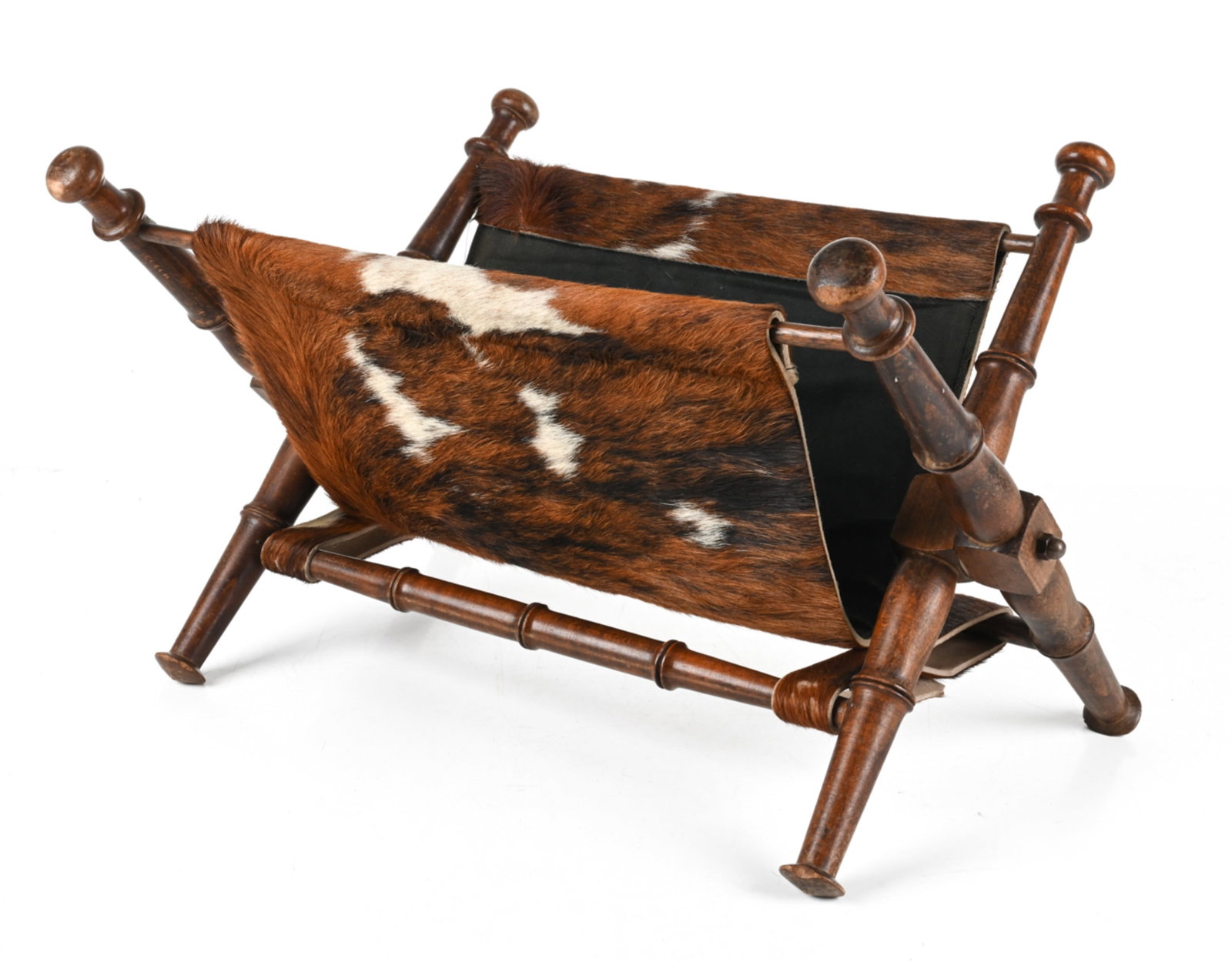 MID-CENTURY COWHIDE MAGAZINE RACK: Dimensions: H 13.5" x W 25" x D 14" Condition: Presents very well overall. A few small chips to feet, scuffs and water spots to frame, a few faint spots of soiling to inner fabric lining. PC130
