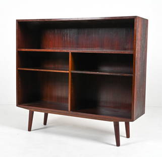 MANNER OF GUNNI OMANN ROSEWOOD BOOKCASE: Scandinavian Mid-Century bookcase in luxurious rosewood; in the manner of Gunni Omann for Omann Jun, c. 1960's. Lower shelves adjustable. Dimensions: H 39.25" x W 43.25" x D 13" Condition: A few minor