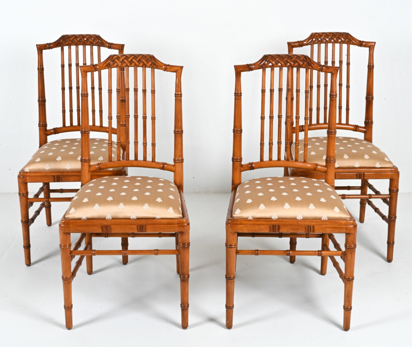 (4) CHINOISERIE FAUX BAMBOO DINING CHAIRS: Contemporary; apparently unlabeled. Seats finished in gold jacquard fabric with bee motif. Dimensions: H 37.75" x W 18.50" x D 22.50" x SH 19" Condition: Grouping presents beautifully overall. Signs o