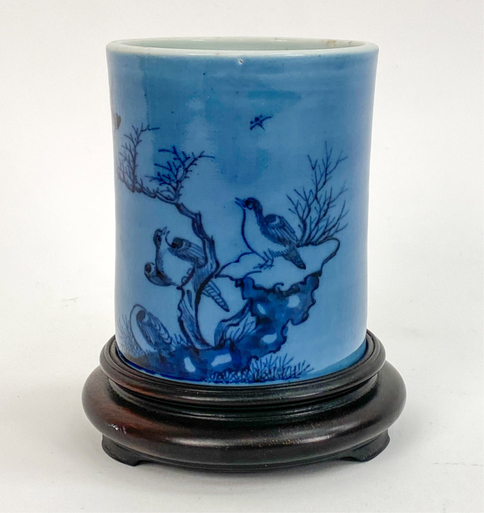MODERN CHINESE BRUSH POT: Porcelain with blue wash background and blue design. Unmarked. Dimensions: (Overall) H 5.75" x Dia 4.5" Condition: One small loss to bottom and one to the rim.