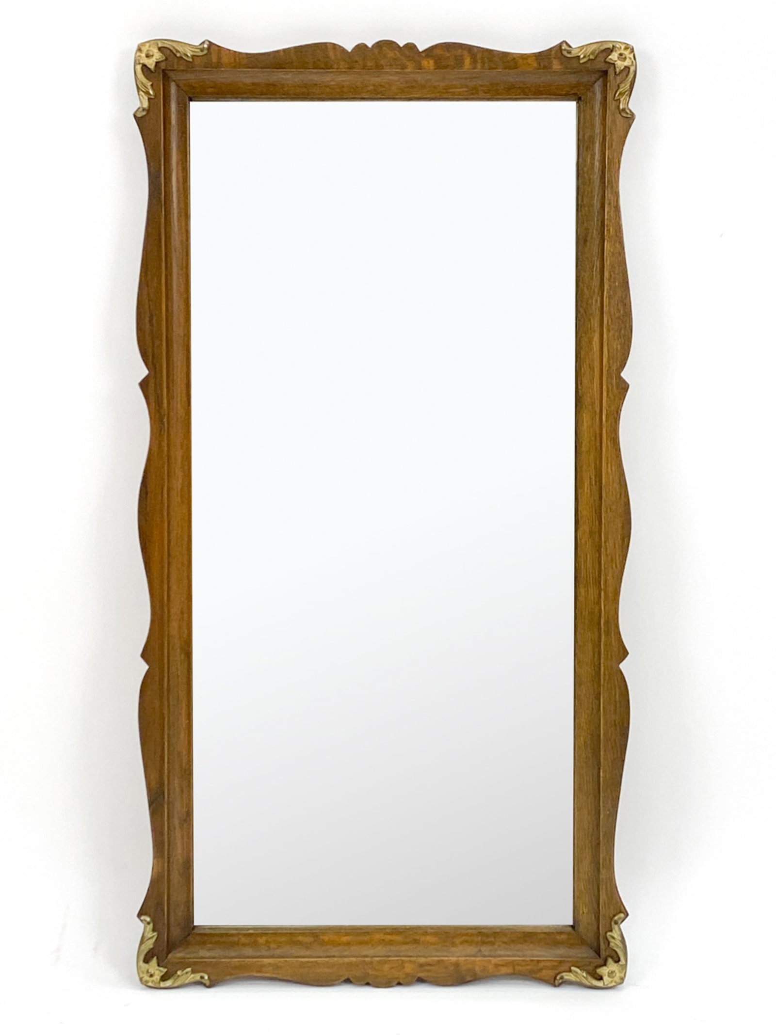 ATTR. HENNING KJAERNULF OAK MIRROR: Wall mirror in carved oak, finished in dark stain. With brass applique. Attributed to Henning Kjaernulf, c. 1960's-1970's. Dimensions: H 37.25" x W 20" Condition: Nicks, dings and scuffs; a few water 