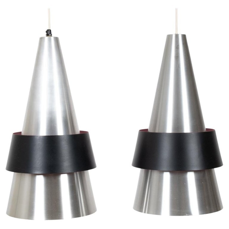 PAIR JO HAMMERBORG, FOG & MORUP "CORONA" LIGHTS: A striking pair of Scandinavian midcentury conical pendant lights in brushed aluminum and black powder coated shades, with sprayed pink interiors. Designed by Jo Hammerborg for Fog & Morup, circa 1963