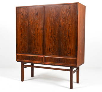 GUNNI OMANN FOR OMANN JUN ROSEWOOD HIGHBOARD: Exquisite highboard or bar cabinet in rosewood, designed by Gunni Omann for Omann Jun; Denmark, c. 1960's. Key included. Dimensions: H 55.25" x W 47" x D 17" Conditions: Minor scuffs and rubs on finis