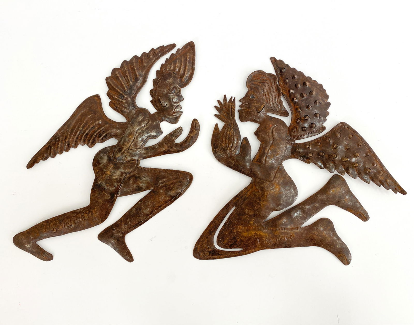 (2) HAITIAN OIL DRUM CUT-OUTS: Kneeling figures. Both signed J. Sylvestre. Dimensions: (Larger) H 16" x W 10" x D 0.5" Condition: Both with rust as found.