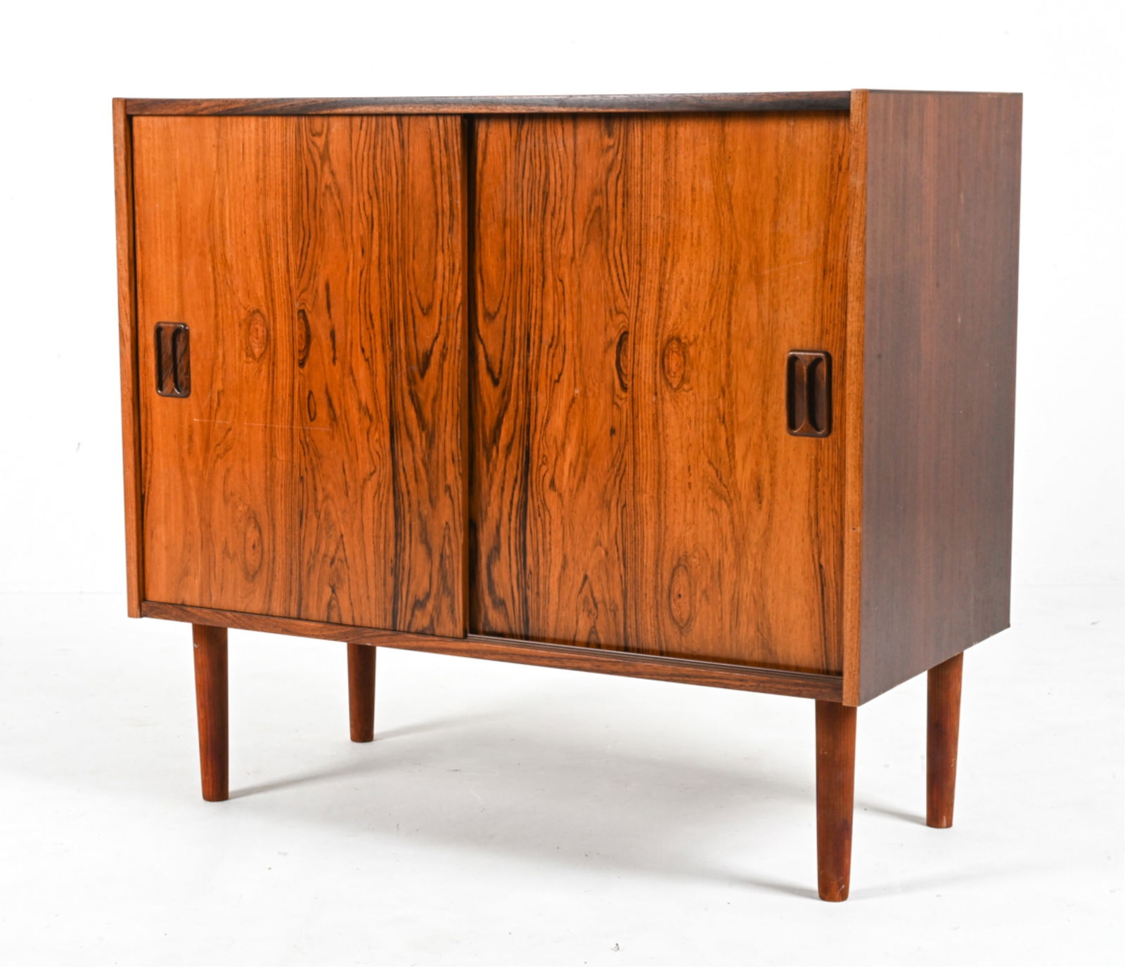SCANDINAVIAN MID-CENTURY ROSEWOOD CABINET: Dimensions: H 31" x W 34.5 " x D 16.5" Condition: Showing light signs of wear including scratches and scuffs to the finish, a few splits to the veneer. Missing a few shelf pins. PD064