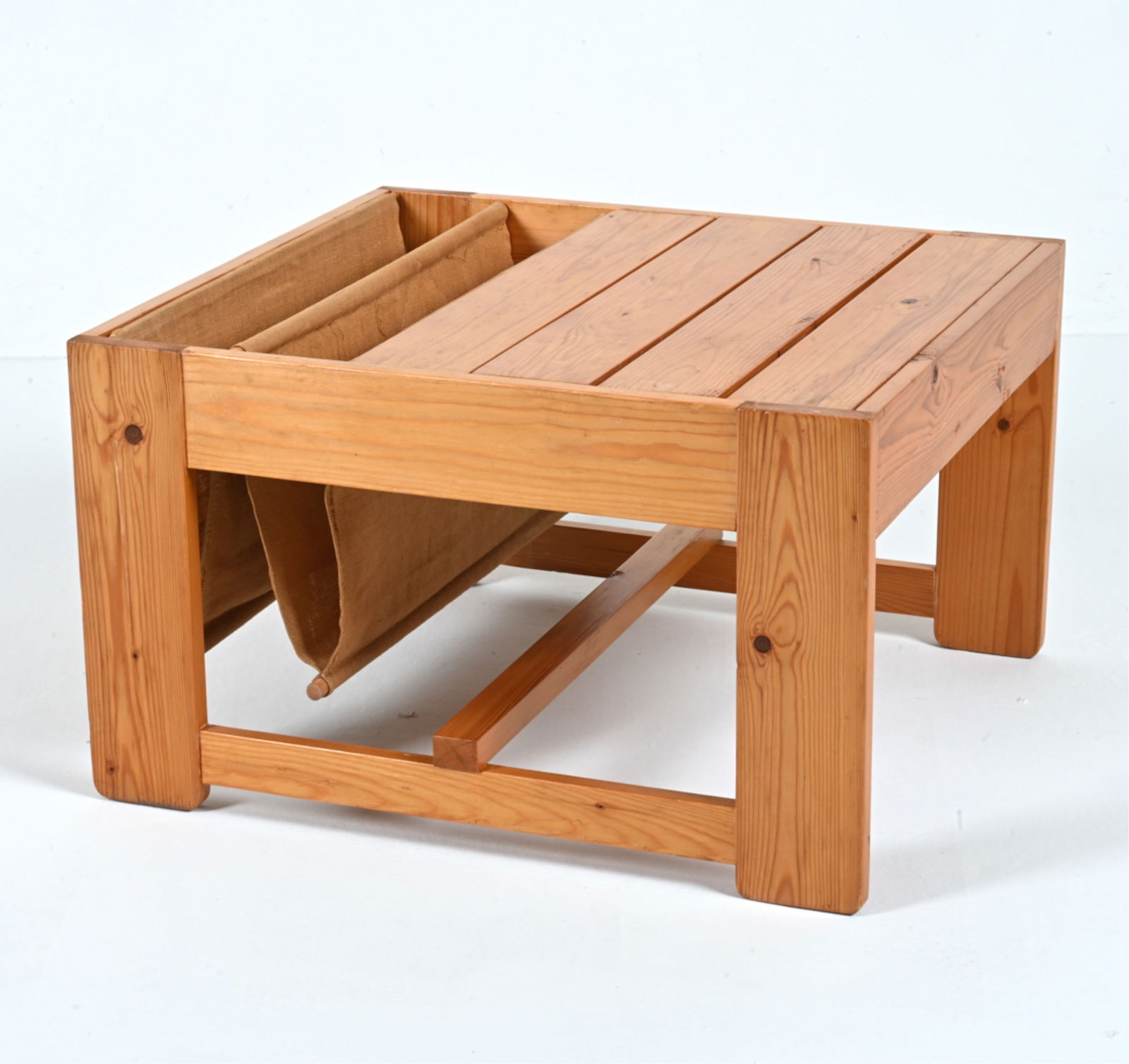 SCANDINAVIAN PINE & LINEN MAGAZINE RACK SIDE TABLE: In the style of Karin Mobring for IKEA. With slatted top. Dimensions: H 14.5" x W 24.5" x D 22.5" Condition: Repaired split to one stretcher, re-gluing to a few joints. Scattered scratches, dings, and