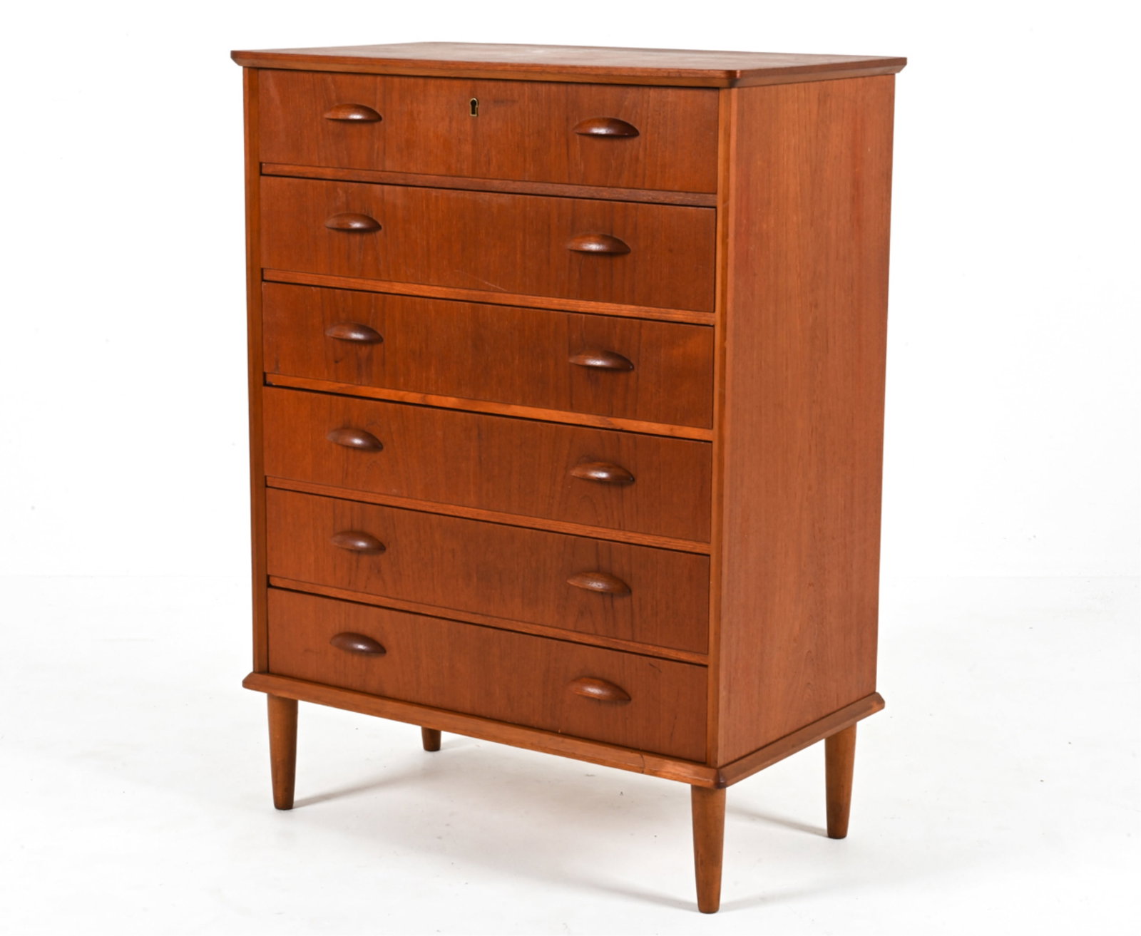 DANISH TEAK GENTLEMAN'S CHEST, C. 1960'S: With sculpted half-moon handles. Key included. Dimensions: H 39.75" x W 29.5" x D 16.25" Condition: Presents very well overall. Very slight musty odor to interior. Pen marks inside drawers. A few fain