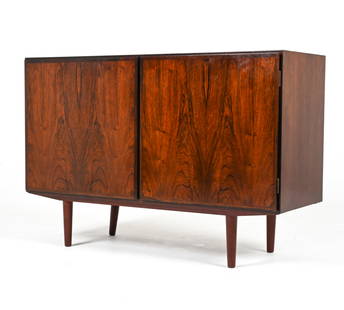 GUNNI OMANN FOR OMANN JUN ROSEWOOD CREDENZA: Denmark, c. 1960's. Dimensions: H 32" x W 47.25" x D 17" Condition: Presents well overall. Minor splitting to wood around back right leg (underneath cabinet). A few scratches and gouged indents to