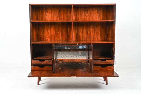 DANISH MID-CENTURY ROSEWOOD BOOKCASE WITH DRY BAR: With adjustable upper shelves and illuminated drop-front bar. Key included. c. 1960's-1970's. Dimensions: H 53.75" x W 55.25" x D 11.5" Condition: Illumination not tested; will likely require