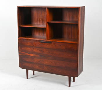 IB KOFOD LARSEN FAARUP ROSEWOOD BOOKCASE DRY BAR: Bookcase with illuminated drop-front bar, designed by Ib Kofod Larsen for Faarup Mobelfabrik, Denmark, c. 1960's. Labeled on back panel. Dimensions: H 54" x W 45.25" x D 11.75" Condition: Presents